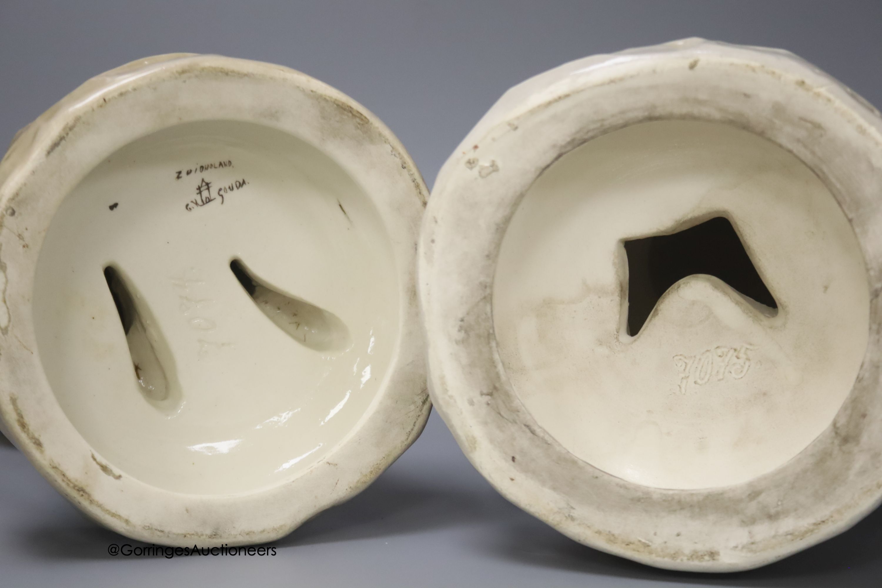 A pair of large Gouda pottery figures of a fisherman and fisherwoman, inscribed 'Scheveningen', 41cm